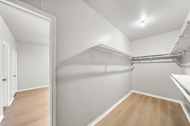 a view of a room with wooden floor