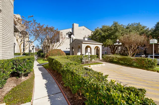 a front view of a house with a yard and mountain view