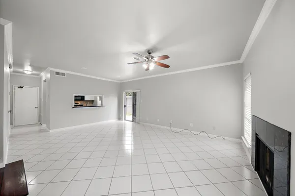 a view of an empty room with a ceiling fan
