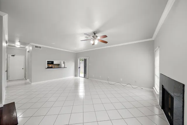 a view of an empty room with a ceiling fan