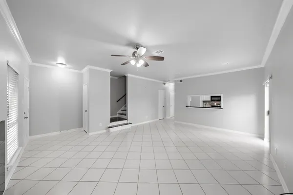 a view of a livingroom with furniture and chandelier fan