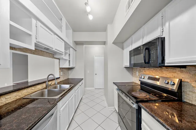 a kitchen that has a sink and a stove
