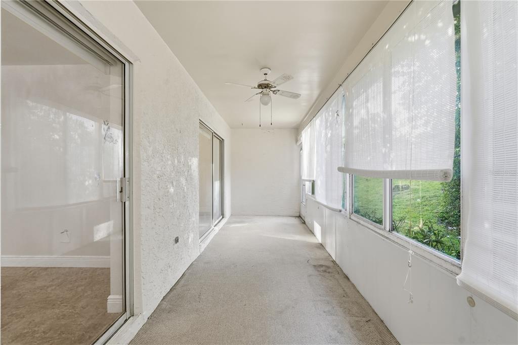 106 Hunter Court Palm Harbor, FL 34684 - Photo 16 of 21 a view of a big room with windows and chandelier fan