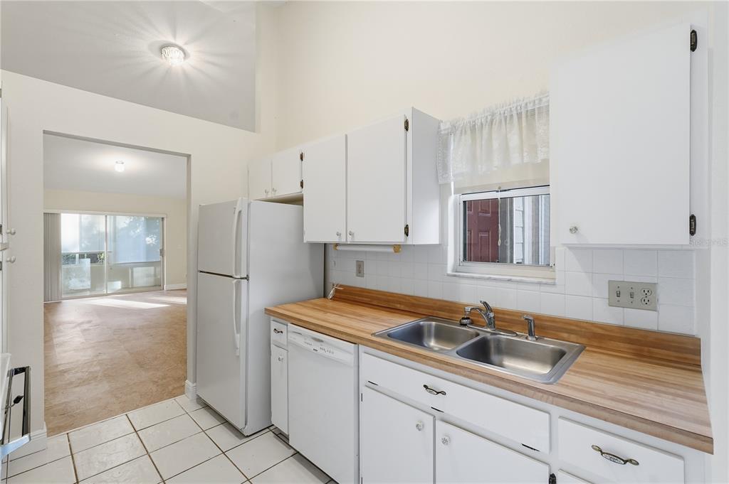 106 Hunter Court Palm Harbor, FL 34684 - Photo 5 of 21 a kitchen with white cabinets and refrigerator