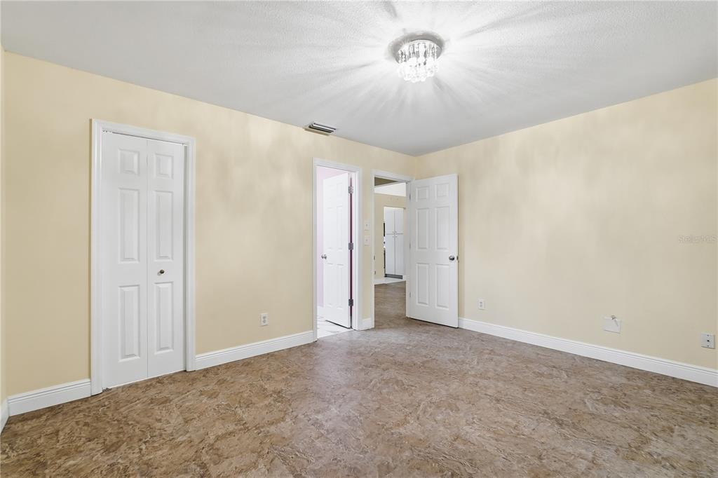 106 Hunter Court Palm Harbor, FL 34684 - Photo 8 of 21 a view of an empty room with a chandelier fan