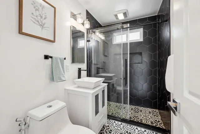 a bathroom with a shower toilet and sink