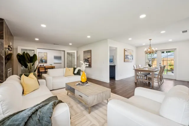 a living room with furniture and kitchen view