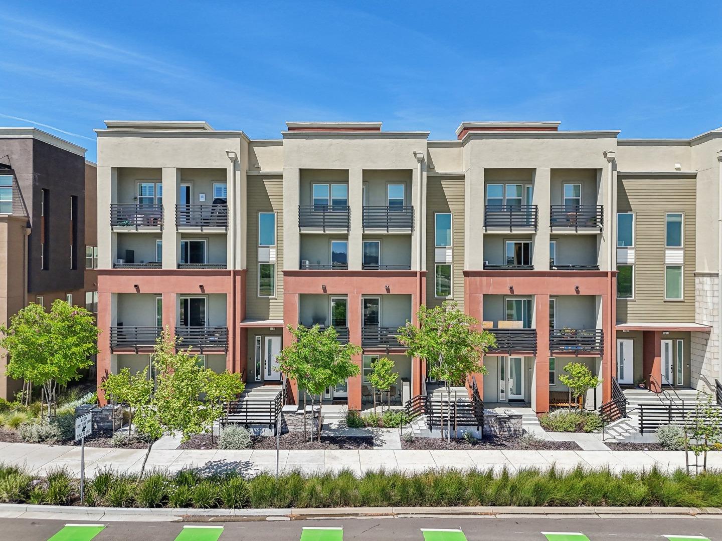 front view of a brick house with a yard
