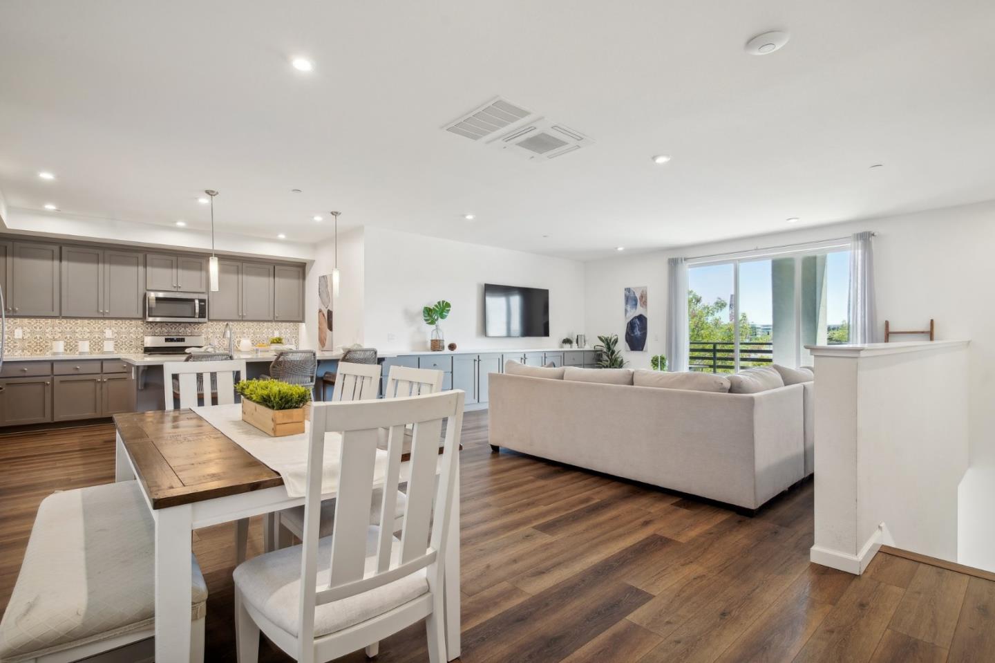5461 Dublin Boulevard Dublin, CA 94568 - Photo 3 of 55 a living room with kitchen island furniture and a wooden floor