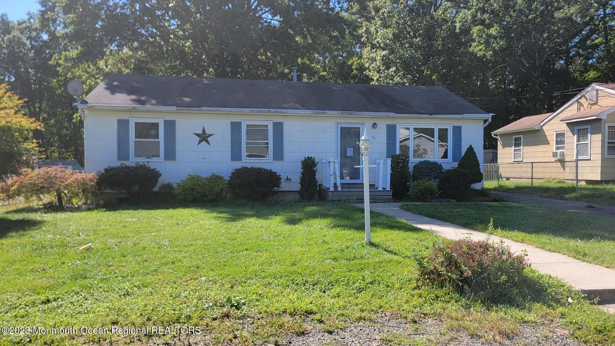 77 Smith Street Howell, NJ 07731 - Photo 1 of 15 a view of a house with a yard and a large tree