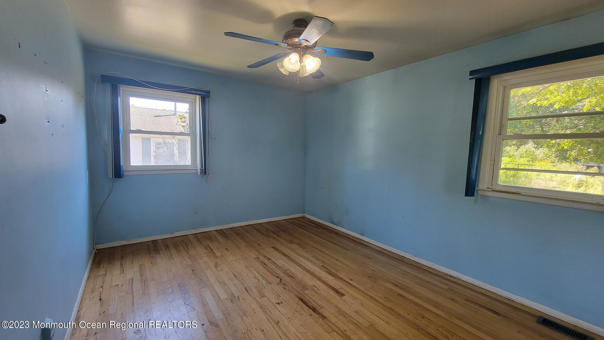 77 Smith Street Howell, NJ 07731 - Photo 11 of 15 wooden floor in an empty room with a window