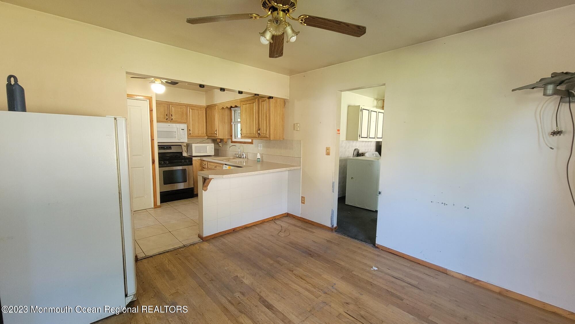 77 Smith Street Howell, NJ 07731 - Photo 5 of 15 a view of a kitchen with a stove cabinets and a ceiling fan