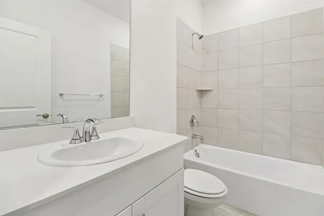 a bathroom with a sink a toilet and a bathtub