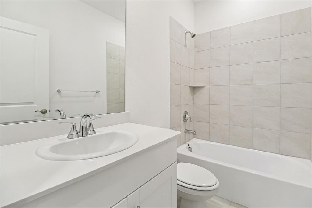 1708 Arches Road Anna, TX 75409 - Photo 13 of 21 a bathroom with a sink a toilet and a bathtub