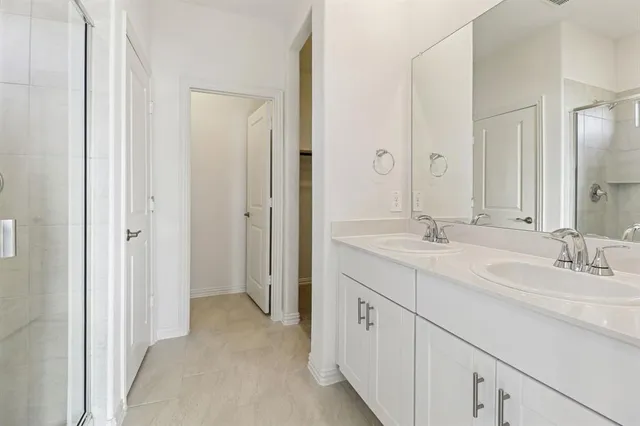 a spacious bathroom with a double vanity sink mirror and