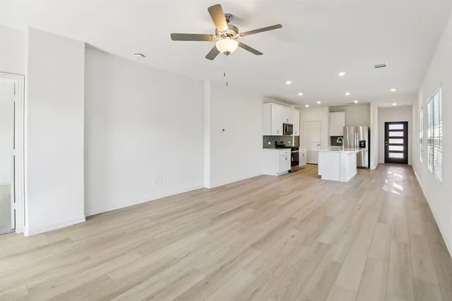 a view of a kitchen with a refrigerator and a window