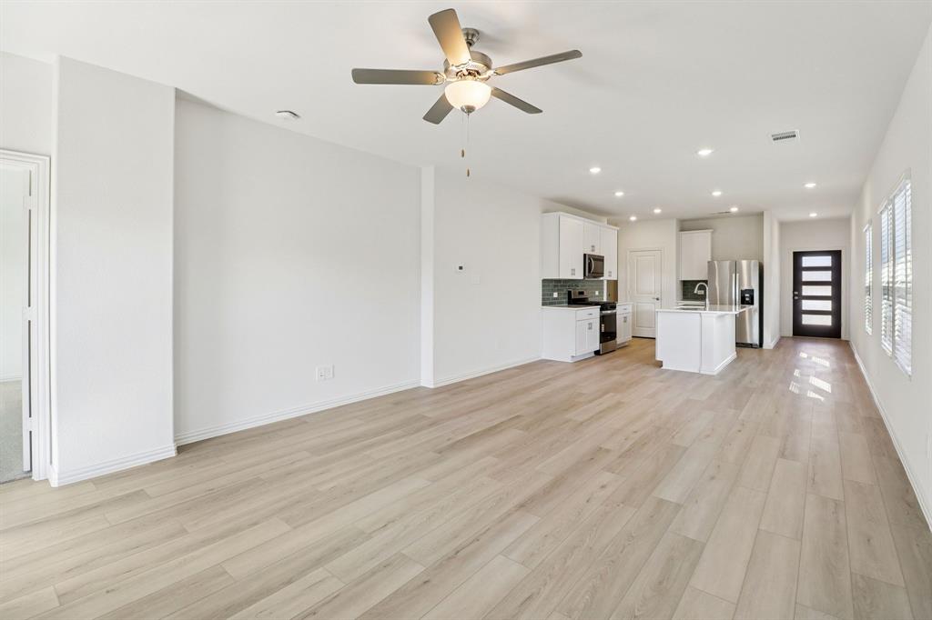 1708 Arches Road Anna, TX 75409 - Photo 7 of 21 a view of a kitchen with a refrigerator and a window