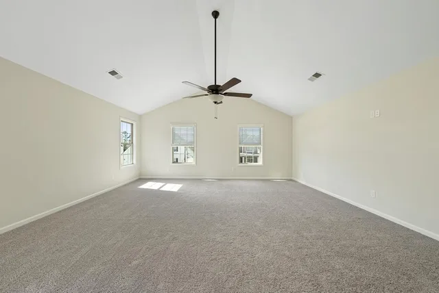 a view of a livingroom with a ceiling fan and window