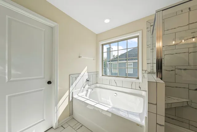 a bathroom with bathtub and a shower