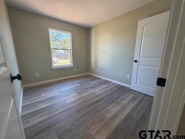 623 North Weldon Street Frankston, TX 75763 - Photo 23 of 29 an empty room with wooden floor and window