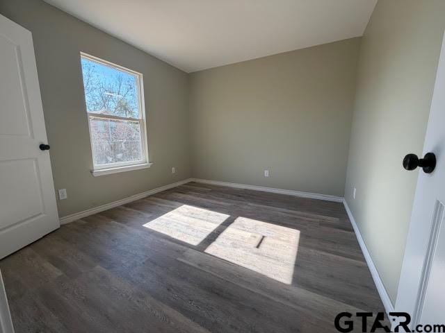 623 North Weldon Street Frankston, TX 75763 - Photo 26 of 29 wooden floor in an empty room with a window