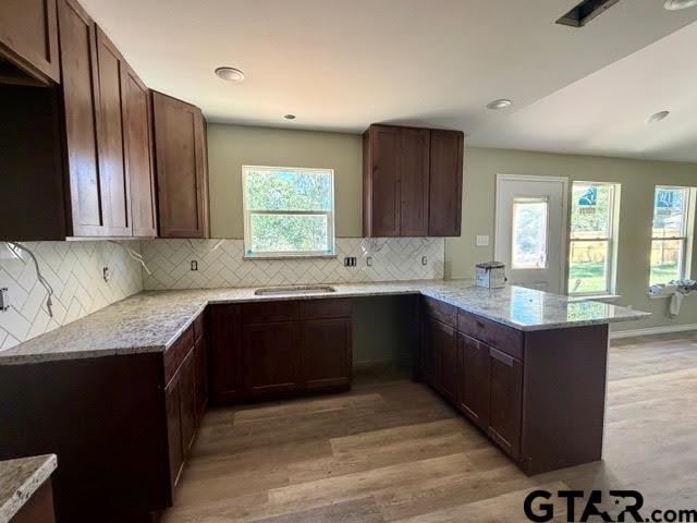 623 North Weldon Street Frankston, TX 75763 - Photo 6 of 29 a kitchen with granite countertop wooden cabinets a sink and a stove
