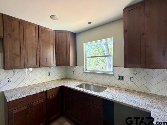 623 North Weldon Street Frankston, TX 75763 - Photo 7 of 29 a kitchen with stainless steel appliances granite countertop wooden cabinets a sink and a stove