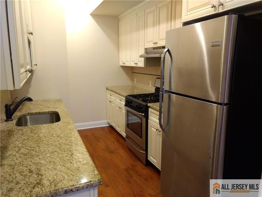 459 Main Street, Unit 1 Metuchen, NJ 08840 - Photo 11 of 21 a kitchen with stainless steel appliances a refrigerator and a sink