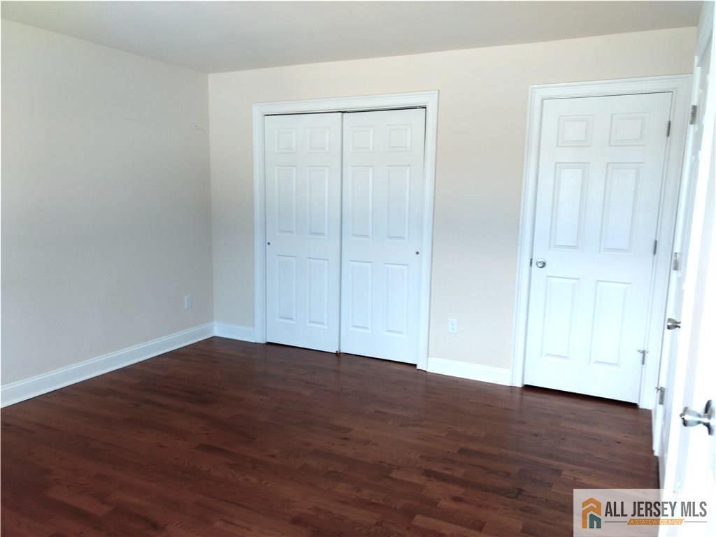 459 Main Street, Unit 1 Metuchen, NJ 08840 - Photo 15 of 21 a view of an empty room with wooden floor