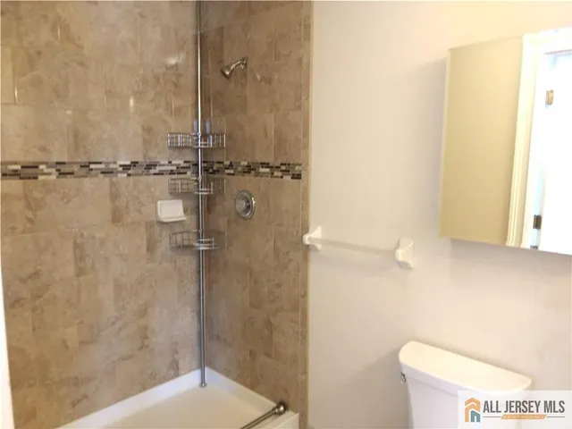 a bathroom with a tub a sink and a window