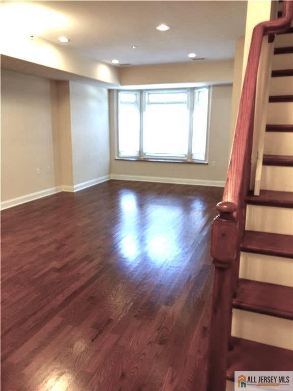 459 Main Street, Unit 1 Metuchen, NJ 08840 - Photo 6 of 21 an empty room with wooden floor and windows