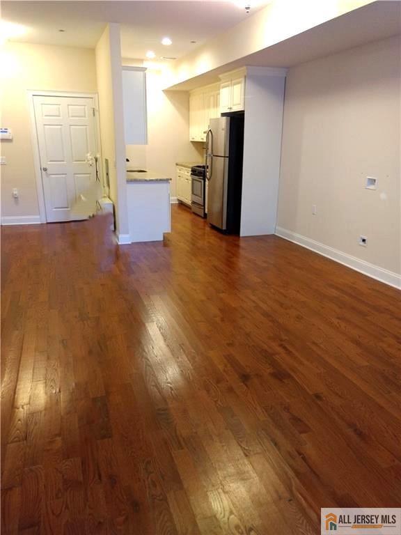 459 Main Street, Unit 1 Metuchen, NJ 08840 - Photo 8 of 21 a view of a refrigerator in kitchen and wooden floor