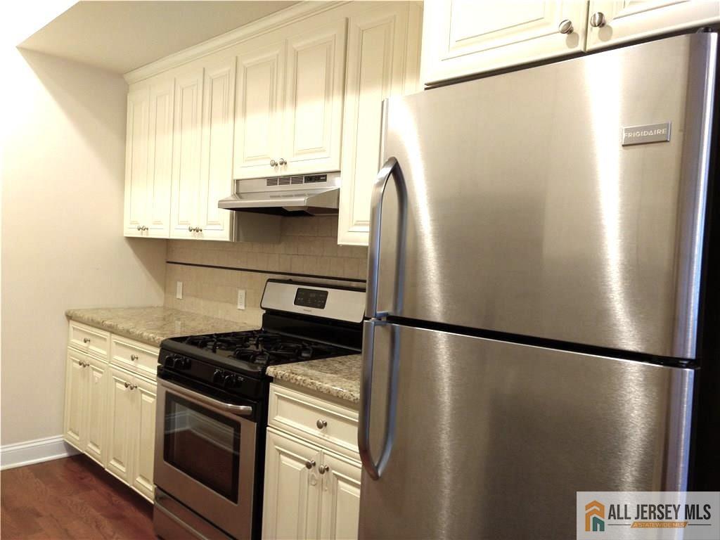 459 Main Street, Unit 1 Metuchen, NJ 08840 - Photo 10 of 21 a view of a kitchen with a stove and a refrigerator