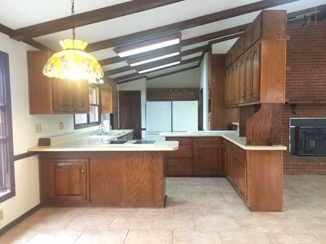 6875 Colaparchee Road, Unit 5A Macon, GA 31210 - Photo 16 of 39 a large kitchen with kitchen island granite countertop a sink and cabinets