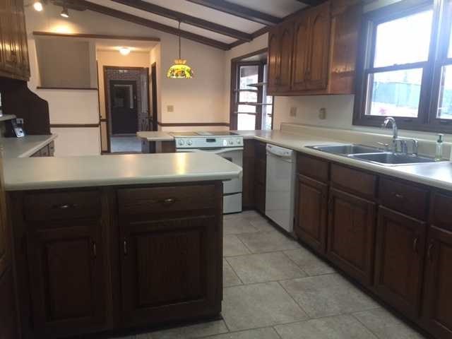 6875 Colaparchee Road, Unit 5A Macon, GA 31210 - Photo 29 of 39 a kitchen with a sink window and cabinets