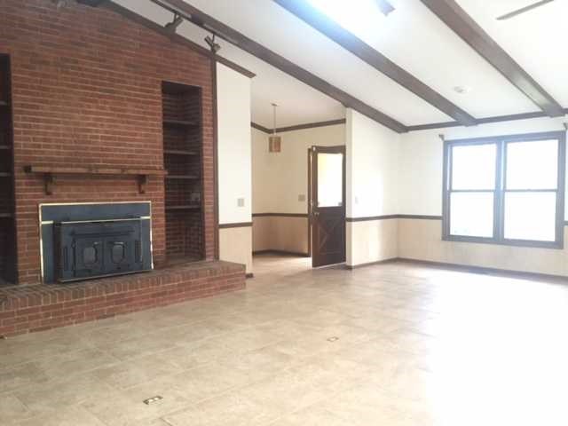 6875 Colaparchee Road, Unit 5A Macon, GA 31210 - Photo 8 of 39 an empty room with windows and fireplace