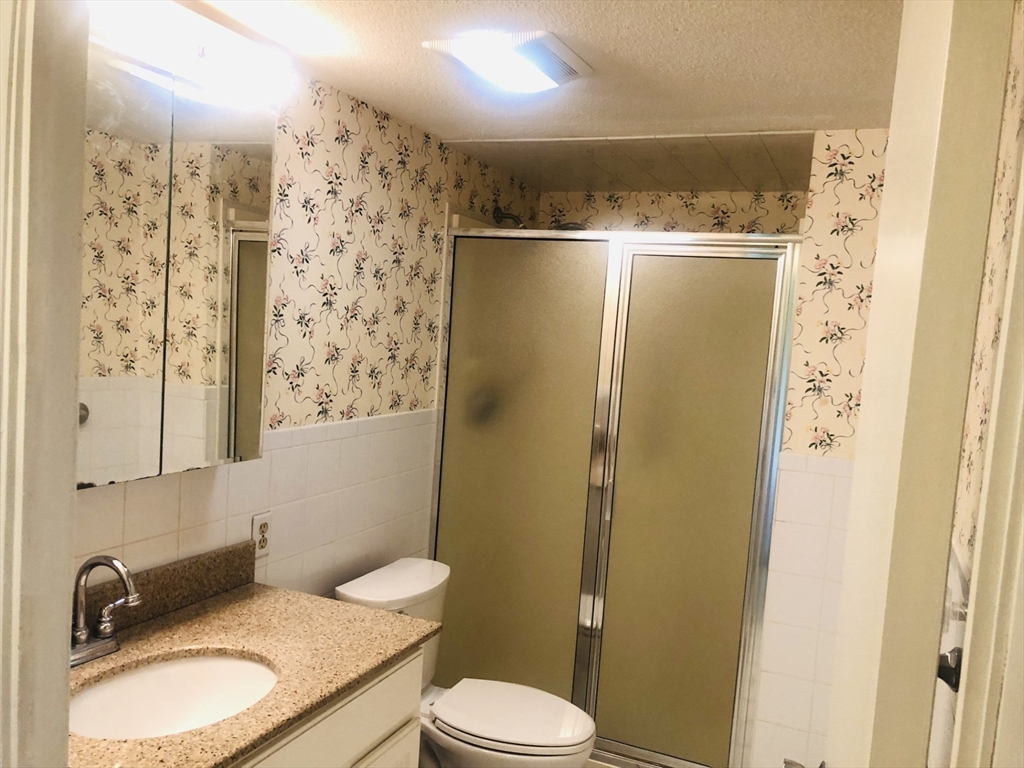 402 Paradise Road, Unit 2L Swampscott, MA 01907 - Photo 6 of 11 a bathroom with a sink toilet and shower