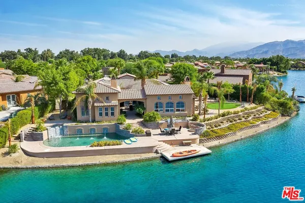 a aerial view of a house with swimming pool garden and lake view