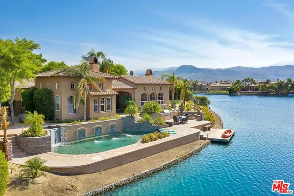 an aerial view of a house with swimming pool garden and patio