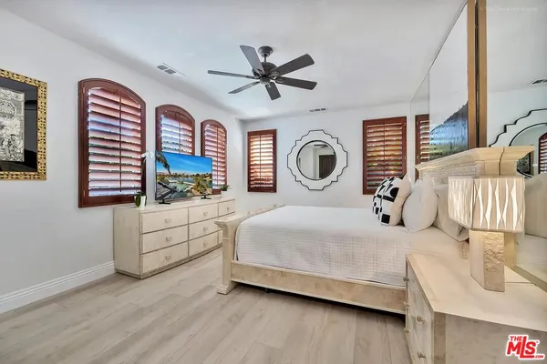a bed room with a bed and a television
