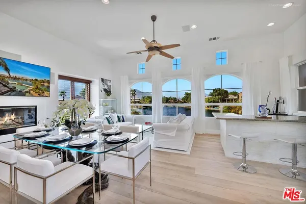 a living room with fireplace furniture and a chandelier
