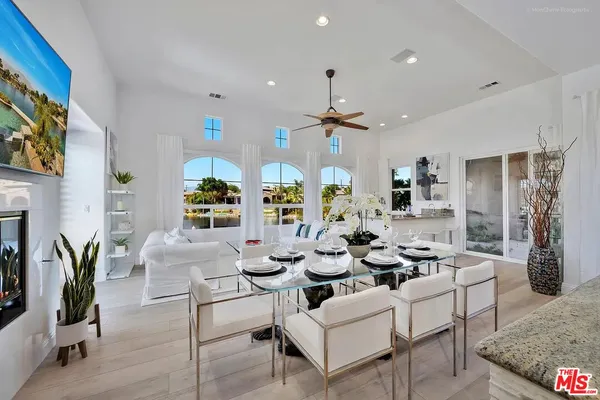 a living room with fireplace furniture and a potted plant