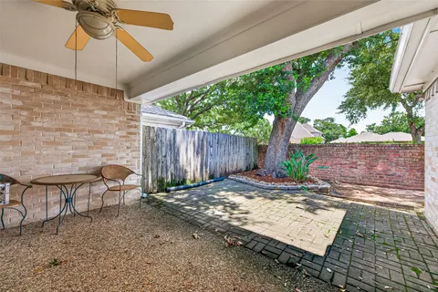 a view of a backyard with plants and outdoor seating
