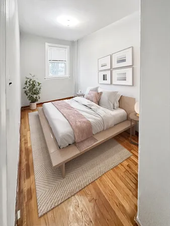 a bedroom with a bed and a painting on the wall