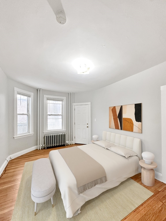 15-17 Pond Street, Unit 173 Boston, MA 02130 - Photo 4 of 9 a spacious bedroom with a bed and a painting on the wall