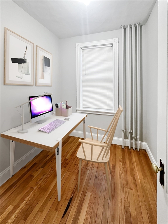 15-17 Pond Street, Unit 173 Boston, MA 02130 - Photo 6 of 9 a view of a workspace with furniture and wooden floor