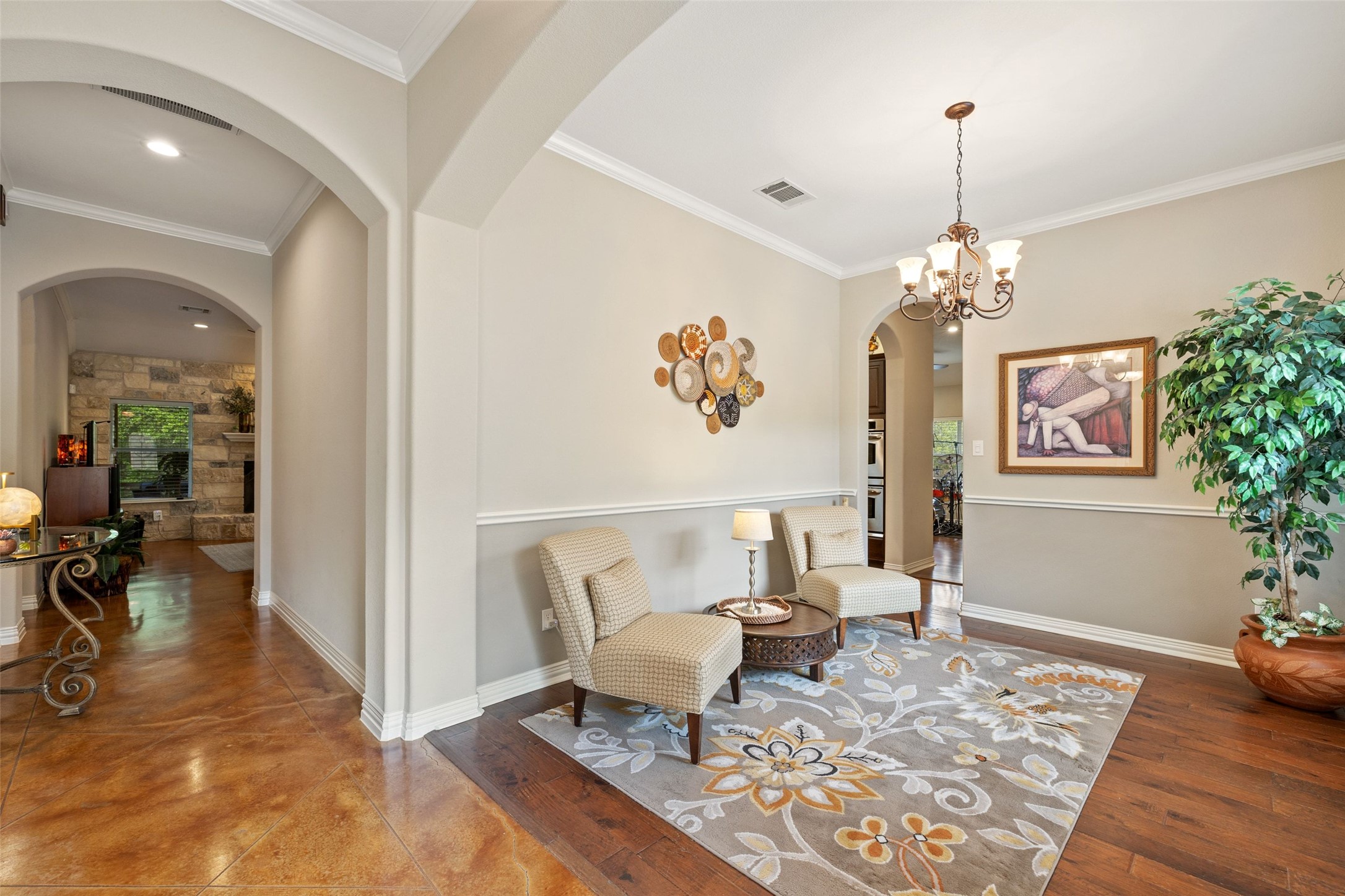15208 Nightingale Lane Austin, TX 78734 - Photo 8 of 40 Living area with ornamental molding, arched walkways, and suspended lighting