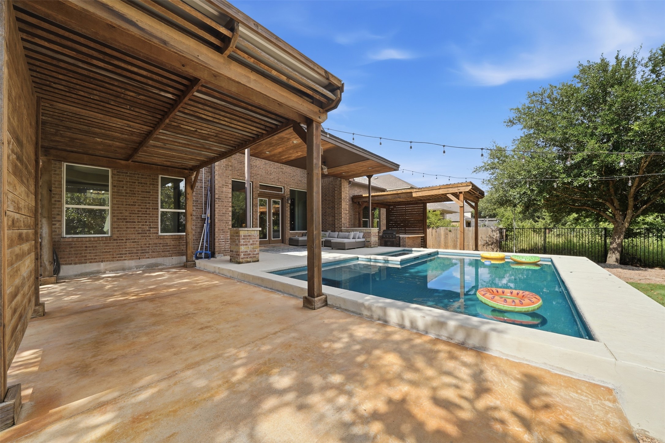 8729 Vantage Point Drive Austin, TX 78737 - Photo 24 of 33 An inviting backyard oasis offers a sparkling pool with an integrated spa, surrounded by a spacious patio, perfect for relaxing.