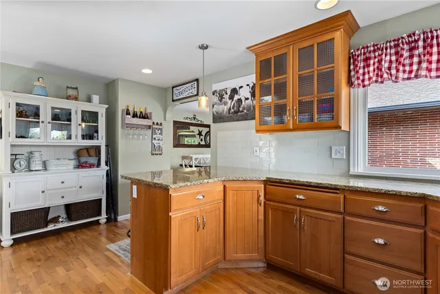 a kitchen with granite countertop cabinets and window
