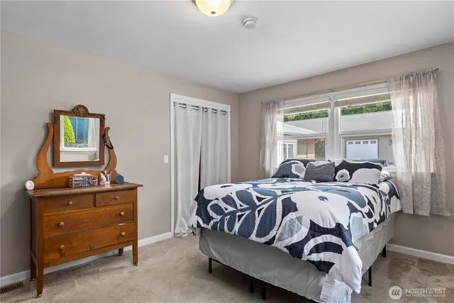 a bed sitting in a bedroom next to a window